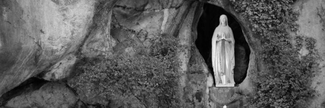 Virgin Mary statue in Lourdes grotto